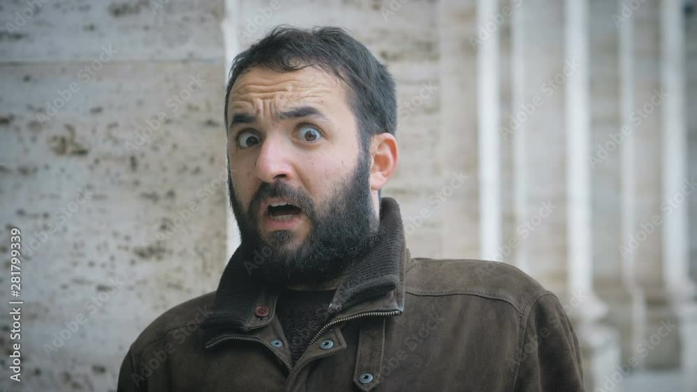 witty latin man making the gesture of fear and shock- outdoor witty latin man making the gesture of fear and shock- outdoor