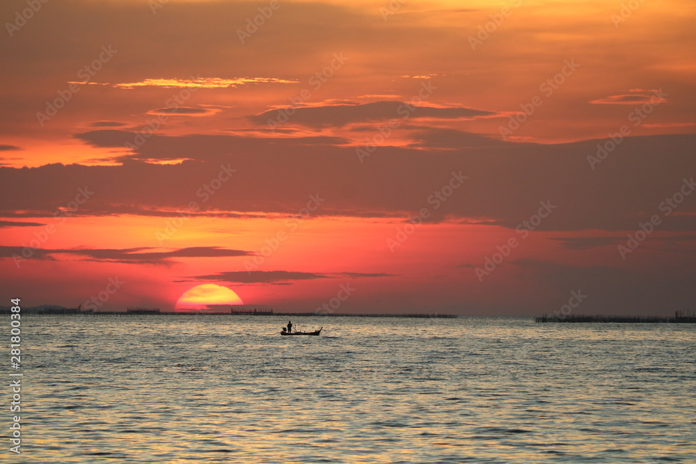 sunset on red sky back evening cloud over horizon sea