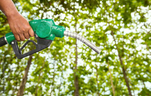 Green conservation. Gas pump nozzle and leaf background. Fuel dispenser on nature background. energy conservation of Nature Concept.
