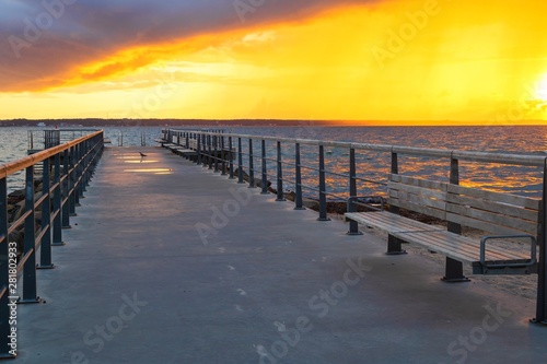 Dramatic summer sunset over sea. Scenic landscape with pier on the sea during beautiful sunset. Sweden