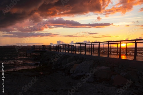 Dramatic summer sunset over sea. Scenic landscape with pier on the sea during beautiful sunset. Sweden