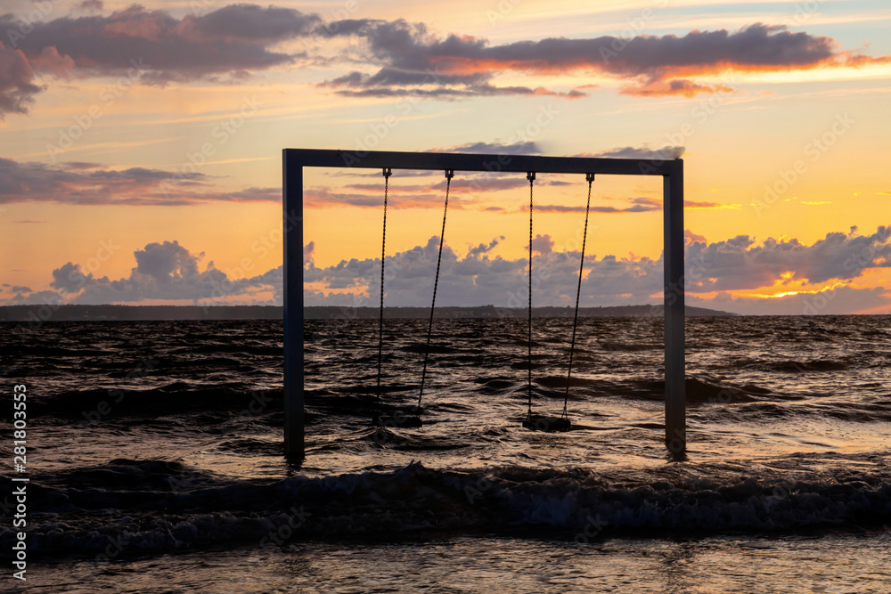 Swing on beautiful sunset sea and beach, Sweden, Helsingborg Swing on beautiful sunset sea and beach, Sweden, Helsingborg