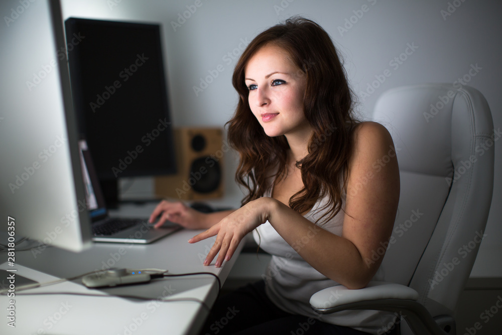 Woman working on a computer in a home office Woman working on a computer in a home office