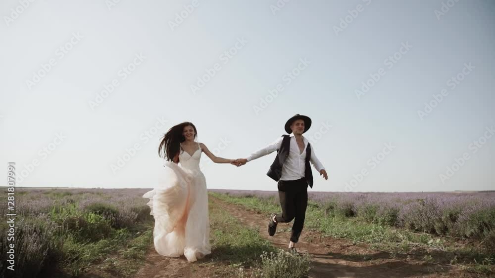Beautiful loving couple in nature in a lavender field Beautiful loving couple in nature in a lavender field