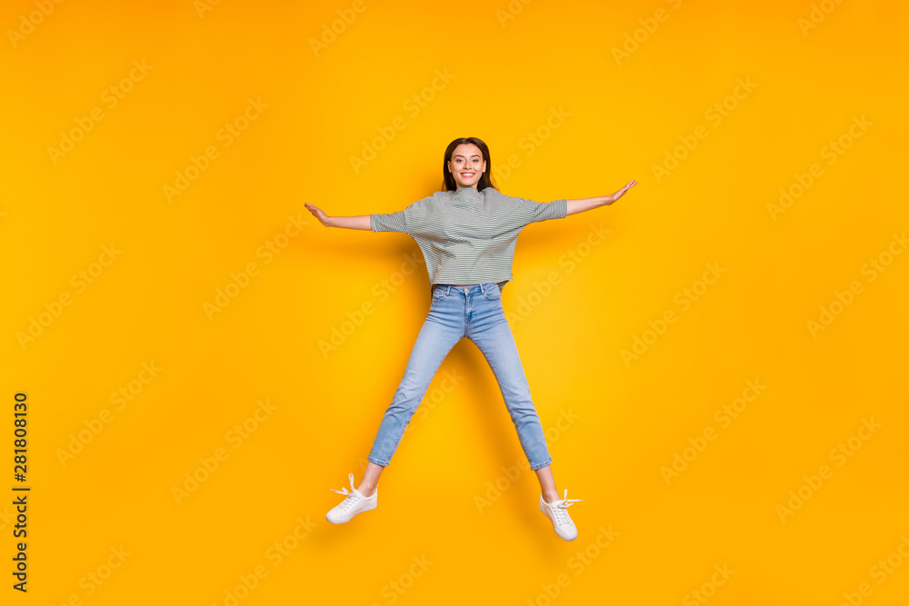 Full length body size photo of jumping excited girlfriend having taken shape of star while isolated with yellow vivid background