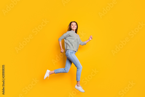 Full length body size photo of excited cheerful girlfriend running towards her dreams while isolated with yellow background © deagreez