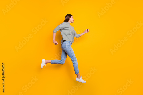 Full length body size photo of girl having noticed someone she likes on another side of road and running up to him while isolated with yellow background