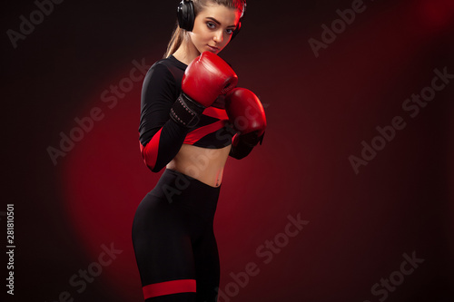 Young woman sportsman boxer on boxing training. Girl wearing gloves, sportswear.
