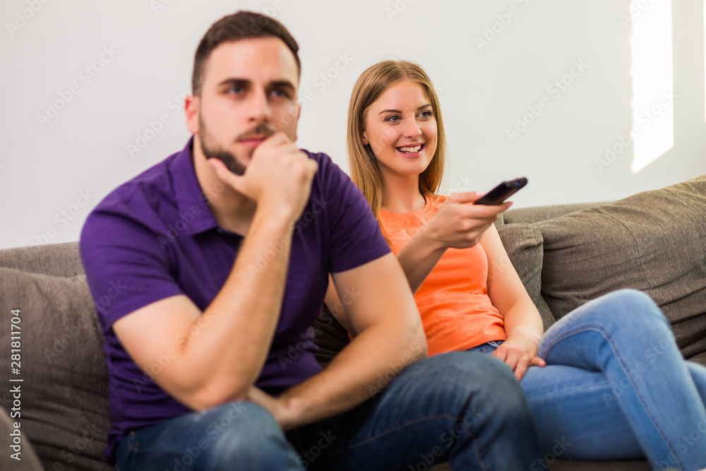 Angry wife and husband are having conflict because wife is watching tv too much. Angry wife and husband are having conflict because wife is watching tv too much.