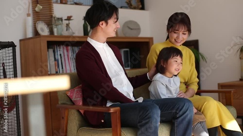 Family sitting together on sofa photo