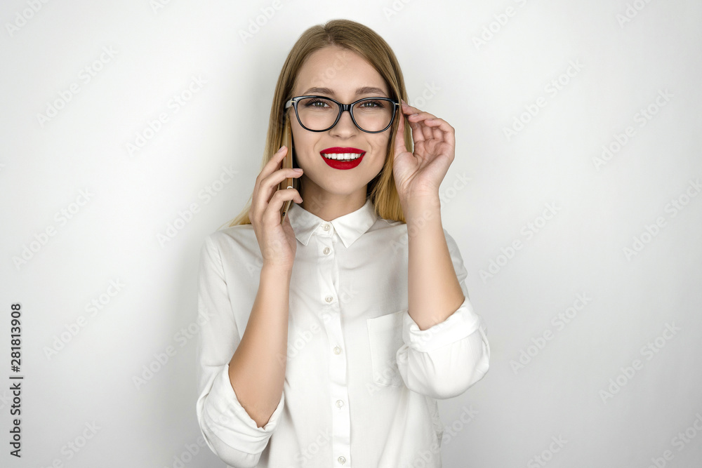 young beautiful business woman in eyeglasses recieved good news from business partner during important phone negotiations isolated white background