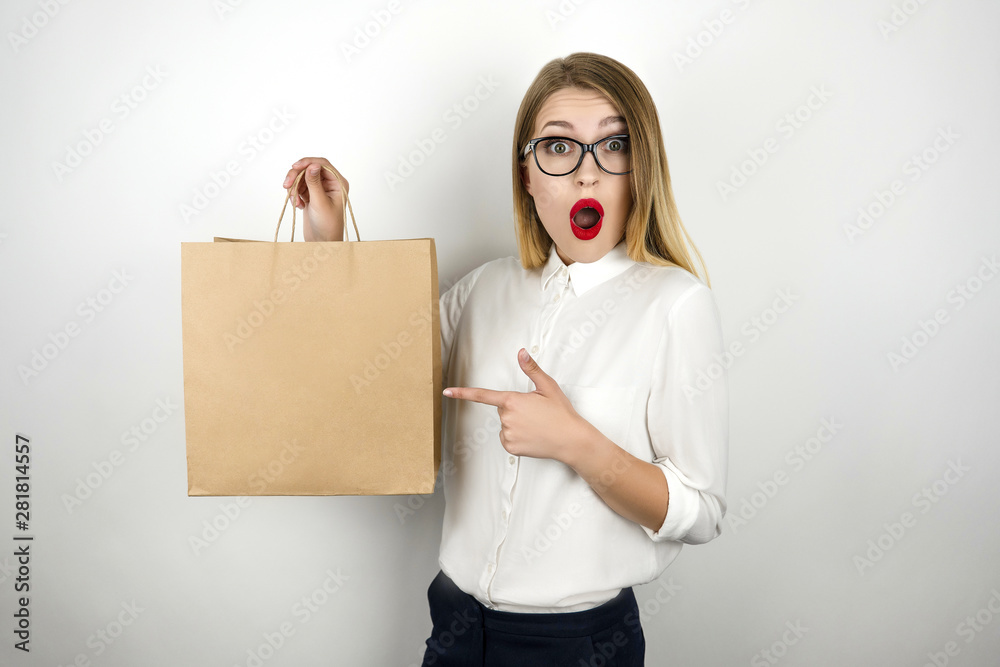 Φωτογραφία young beautiful business woman in eyeglasses holding awaited lunch in paper bag