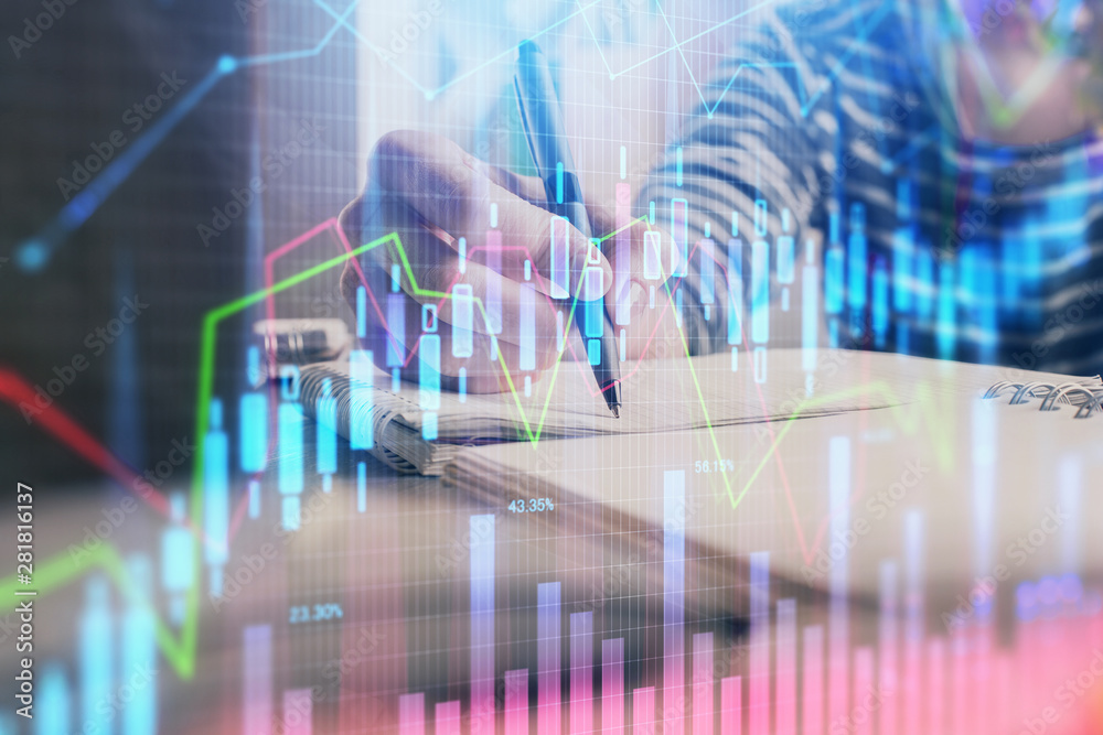 Financial forex graph drawn over hands taking notes background. Concept of research. Double exposure Financial forex graph drawn over hands taking notes background. Concept of research. Double exposure