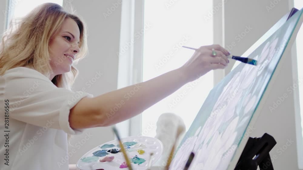 Creative painter paints a colorful picture in her studio Creative painter paints a colorful picture in her studio