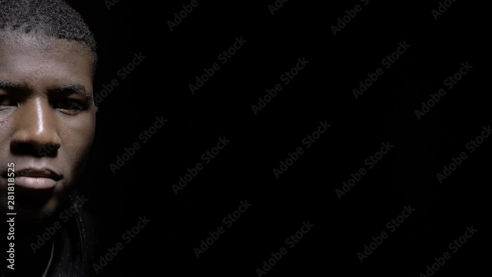 Sad lonely black african migrant in the dark staring at camera.Sadness,troubles Sad lonely black african migrant in the dark staring at camera.Sadness,troubles