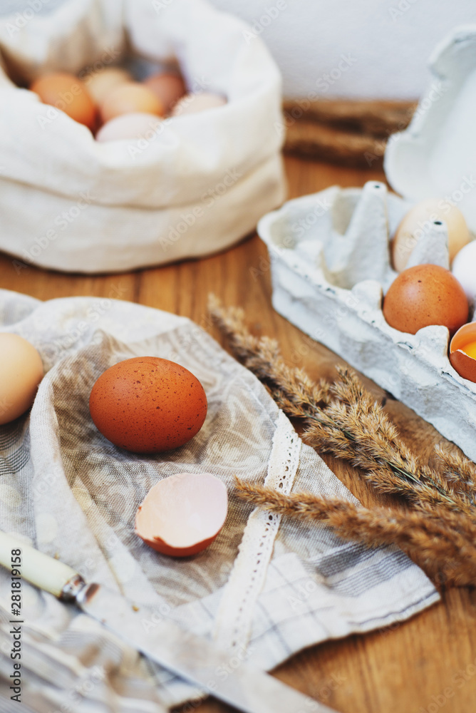 homemade organic eggs in eco bag and recycled tray on wooden background homemade organic eggs in eco bag and recycled tray on wooden background
