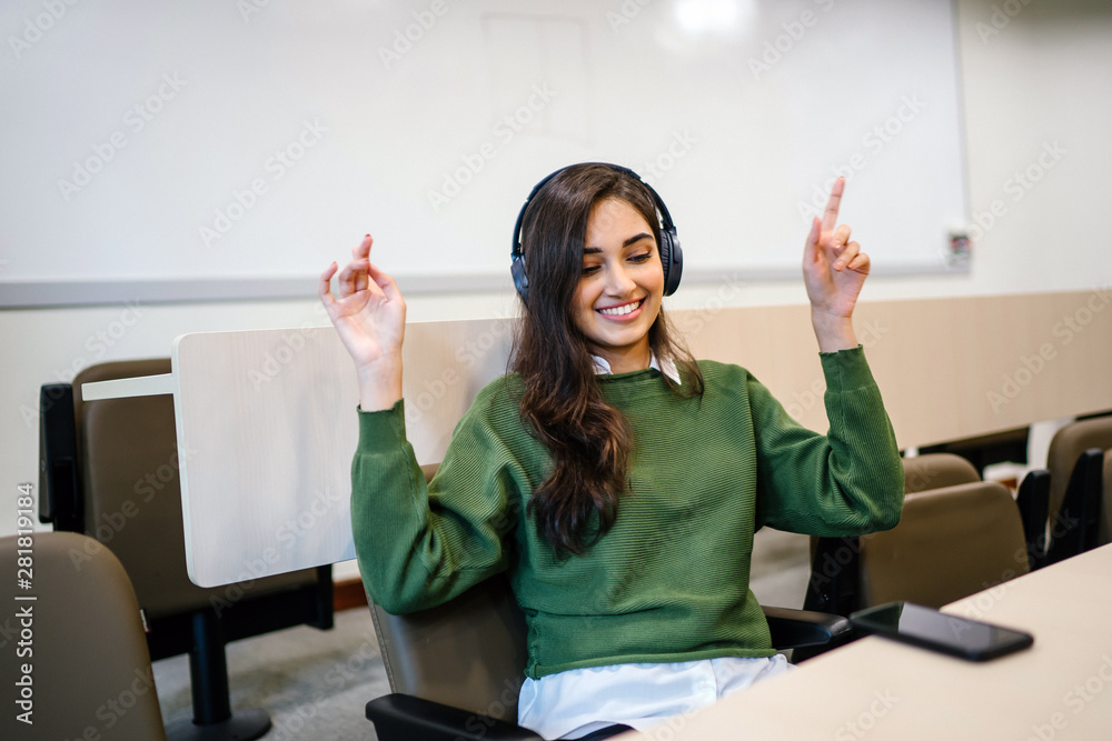 Φωτογραφία Portrait of a young, beautiful, preppy and attractive Indian Asian woman as she smiles and dances