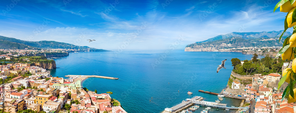 Panoramic collage of cliff coastline Sorrento and Gulf of Naples, Italy. Ripe yellow lemons in foreground.