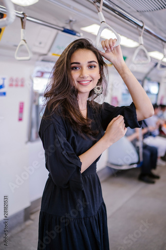 Photography Portrait of a tall, slim, elegant, attractive, slim and beautiful Indian Asian woman taking the train alone