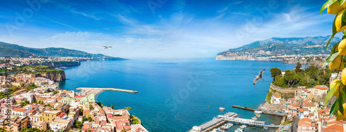 Panoramic collage of cliff coastline Sorrento and Gulf of Naples, Italy. Ripe yellow lemons in foreground.