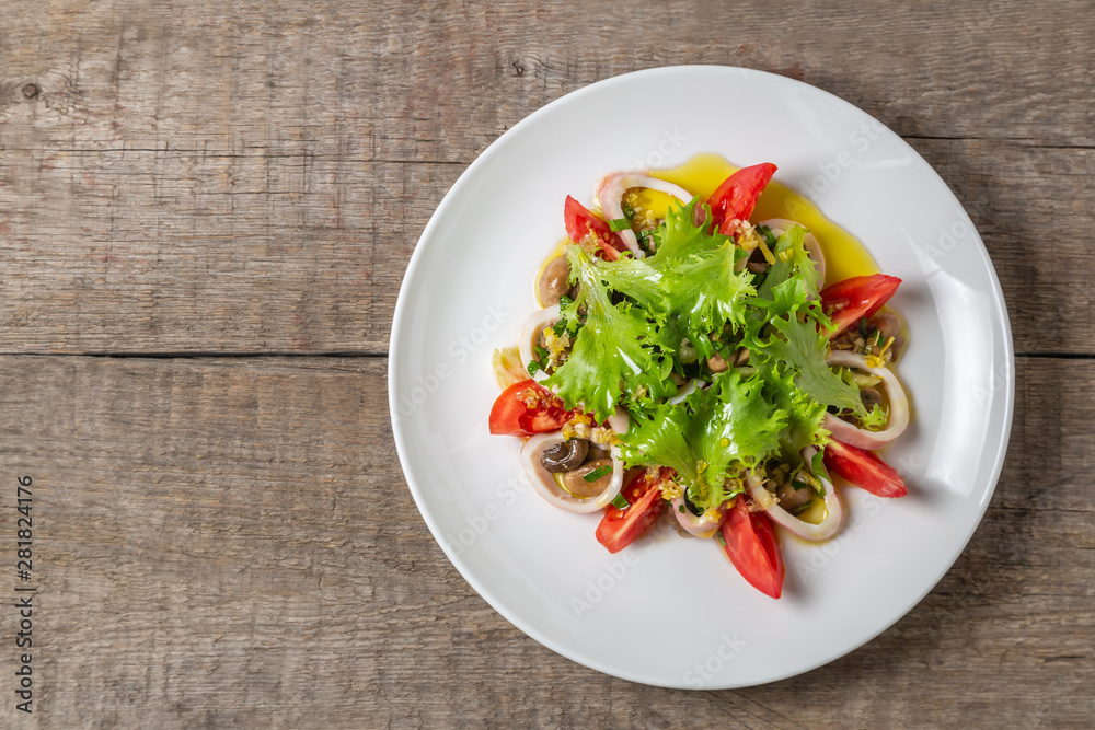Salad of squid, mushrooms, and vegetables. The view from the top. Copy-space. Salad of squid, mushrooms, and vegetables. The view from the top. Copy-space.