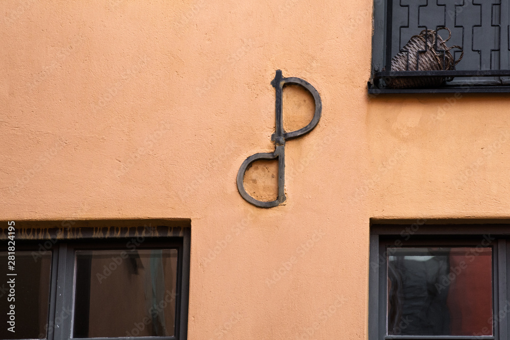 Ankarslut or anchor plate detail of a building made from wrought iron. Texture of the wall with a metal element, close-up. Background