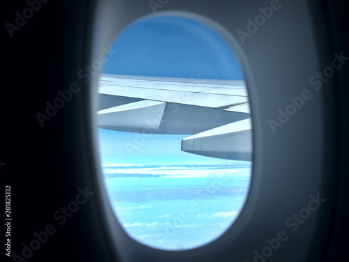 Airplane wing with jet engines from window.