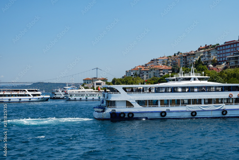 Istanbul, Turkey, Bosphorus Bridge and Uskudar Coast. Pleasure boats sail on the Bosphorus