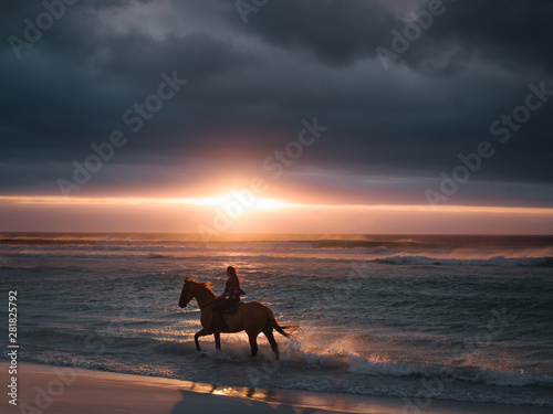 Female riding horse along the beach © Jacob Lund
