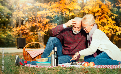 happy senior couple having a picnic photo