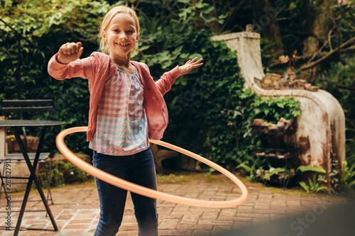 Girl playing with a hoopla ring