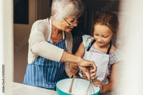 Obraz na plátne Granny and kid cooking in kitchen