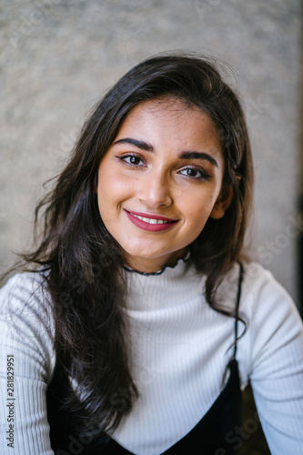 Close up portrait of a young, beautiful Indian Asian Punjabi Singaporean girl. The girl is a student. She has an intense and intelligent gaze.