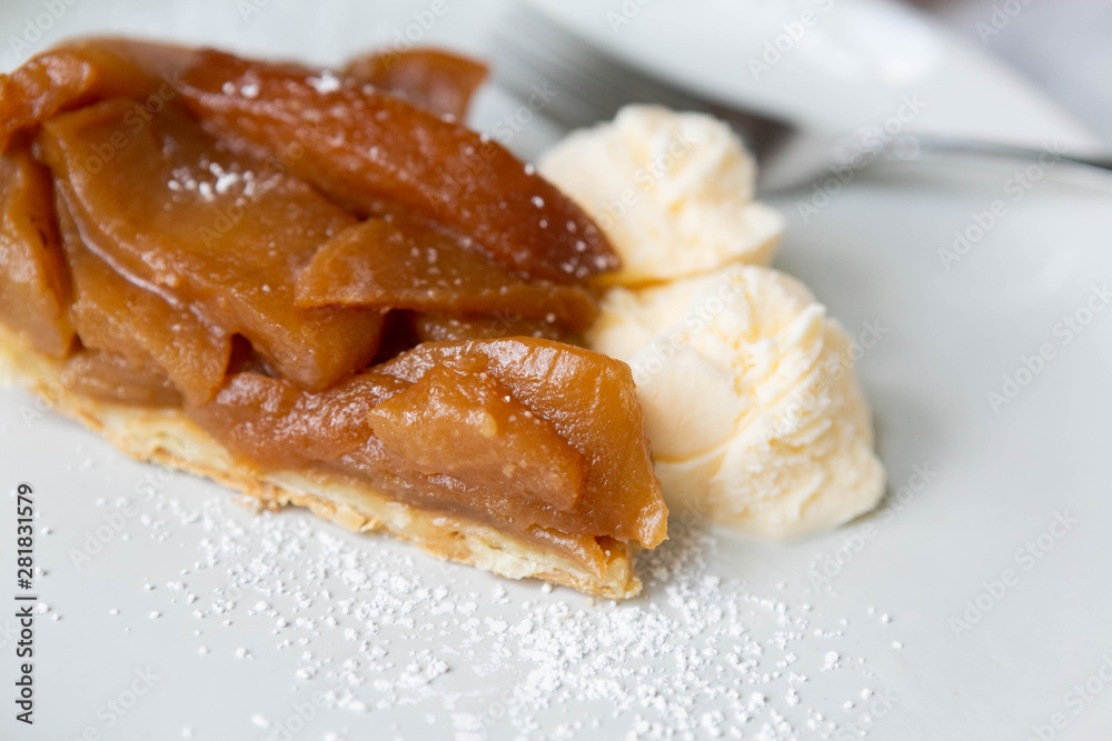 Slice of Caramel Apple Pie Tart with Vanilla Ice Cream, White Marble Background, Pink Napkin, Fork, Honey crisp Dessert Slice of Caramel Apple Pie Tart with Vanilla Ice Cream, White Marble Background, Pink Napkin, Fork, Honey crisp Dessert