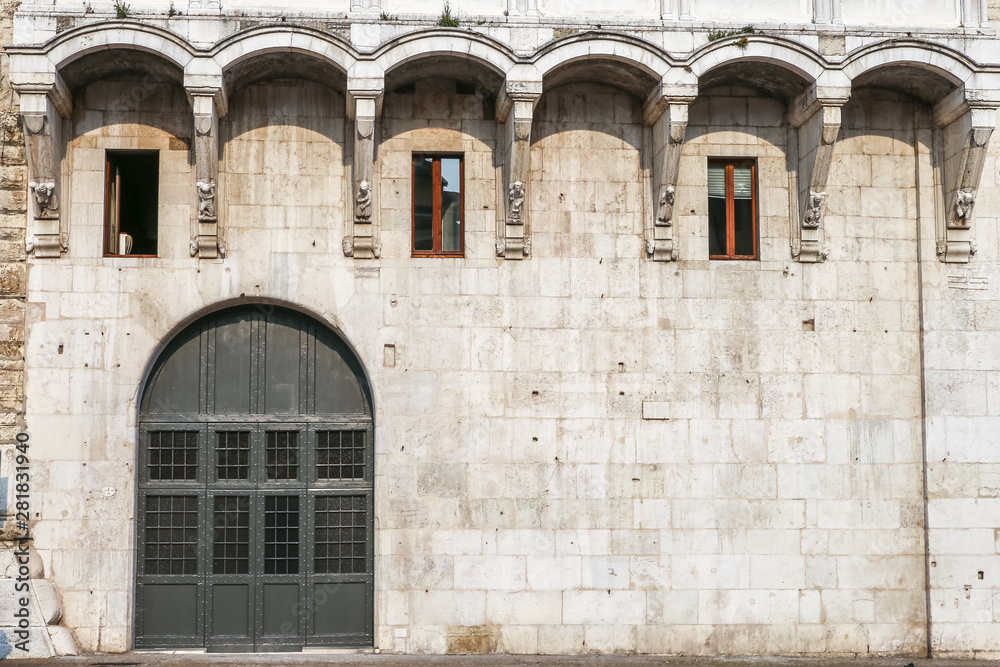 Brescia (Italy): facade and door of the Broletto building Brescia (Italy): facade and door of the Broletto building