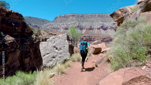 Woman hiking in Grand Canyon. Healthy active lifestyle image of hiking young multiracial female hiker in Grand Canyon, Adventure and travel concept. Women hiking in USA national park.
