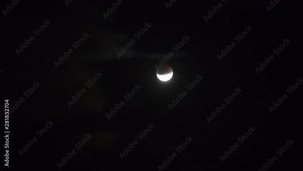 Moon moving on dark night sky with clouds during partial eclipse. Full HD clip Moon moving on dark night sky with clouds during partial eclipse. Full HD clip