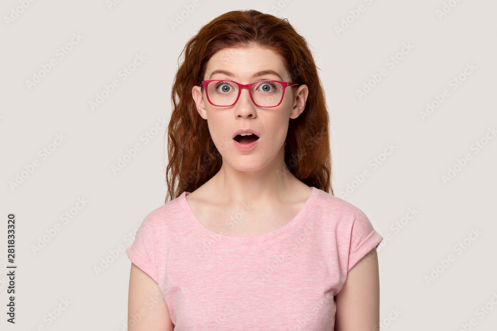 Head shot portrait funny redhead woman open mouth feels amazed Head shot portrait funny redhead woman open mouth feels amazed