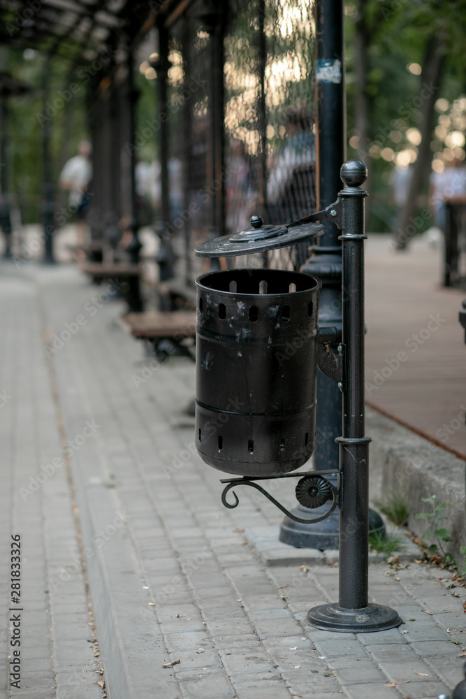 forged black trash can on the street in the Park adorns the city forged black trash can on the street in the Park adorns the city