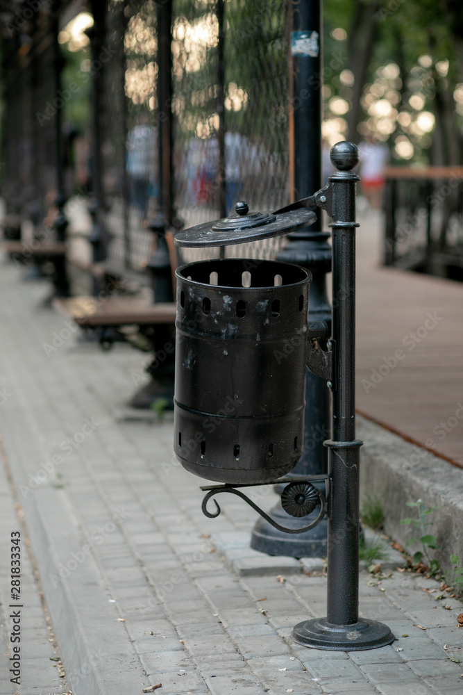 forged black trash can on the street in the Park adorns the city forged black trash can on the street in the Park adorns the city