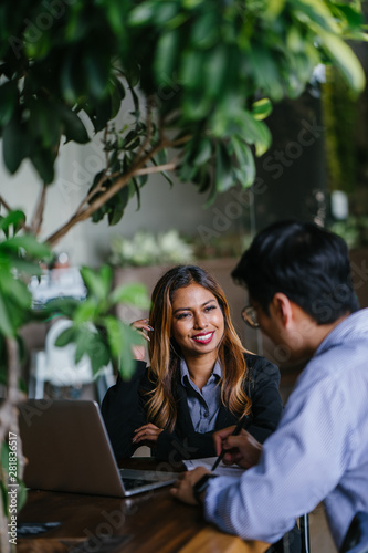 Canvas Print A young, tanned and attractive Southeast Asian woman in a suit is interviewing for a job to advance her career