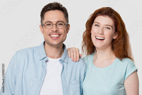 Head shot studio portrait attractive laughing millennial couple studio shot