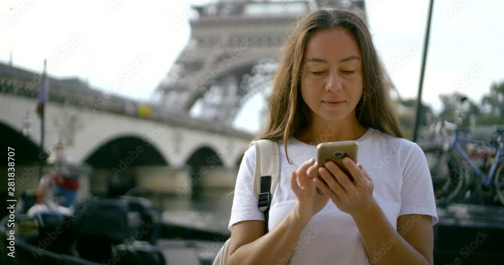 woman with phone against bridge and Eiffel Tower slow motion woman with phone against bridge and Eiffel Tower slow motion