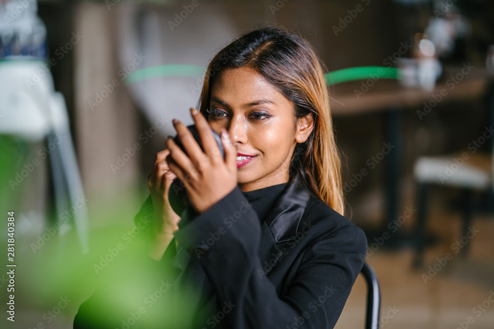 A portrait of a beautiful, young and attractive Asian woman manager, professional or entrepreneur in a business suit putting on foundation, mascara and blusher before her business meeting. A portrait of a beautiful, young and attractive Asian woman manager, professional or entrepreneur in a business suit putting on foundation, mascara and blusher before her business meeting.