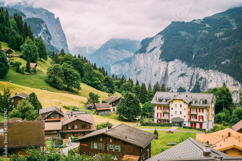 The town Wengen in the Alps mountains in Switzerland in a green summer landscape