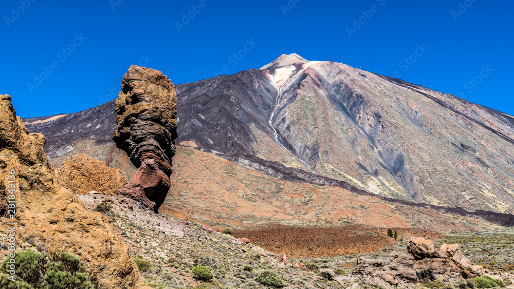 Stone finger on the background of mountain peaks