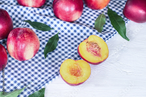 nectarines on the table. background with whole and nectarine halves nectarine closeup.