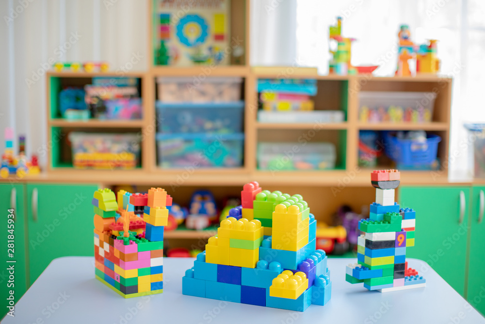 colorful plastic bricks at the table.children's toys collection on the  tabletop in the children's room or in the kindergarten