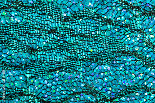 Abstract background of blue lace and sequins to look like the sea or fish scales photo