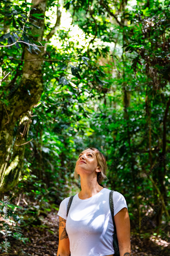 Woman exploring in tropical rainforest on Queensland's Gold Coast Hinterland Woman exploring in tropical rainforest on Queensland's Gold Coast Hinterland